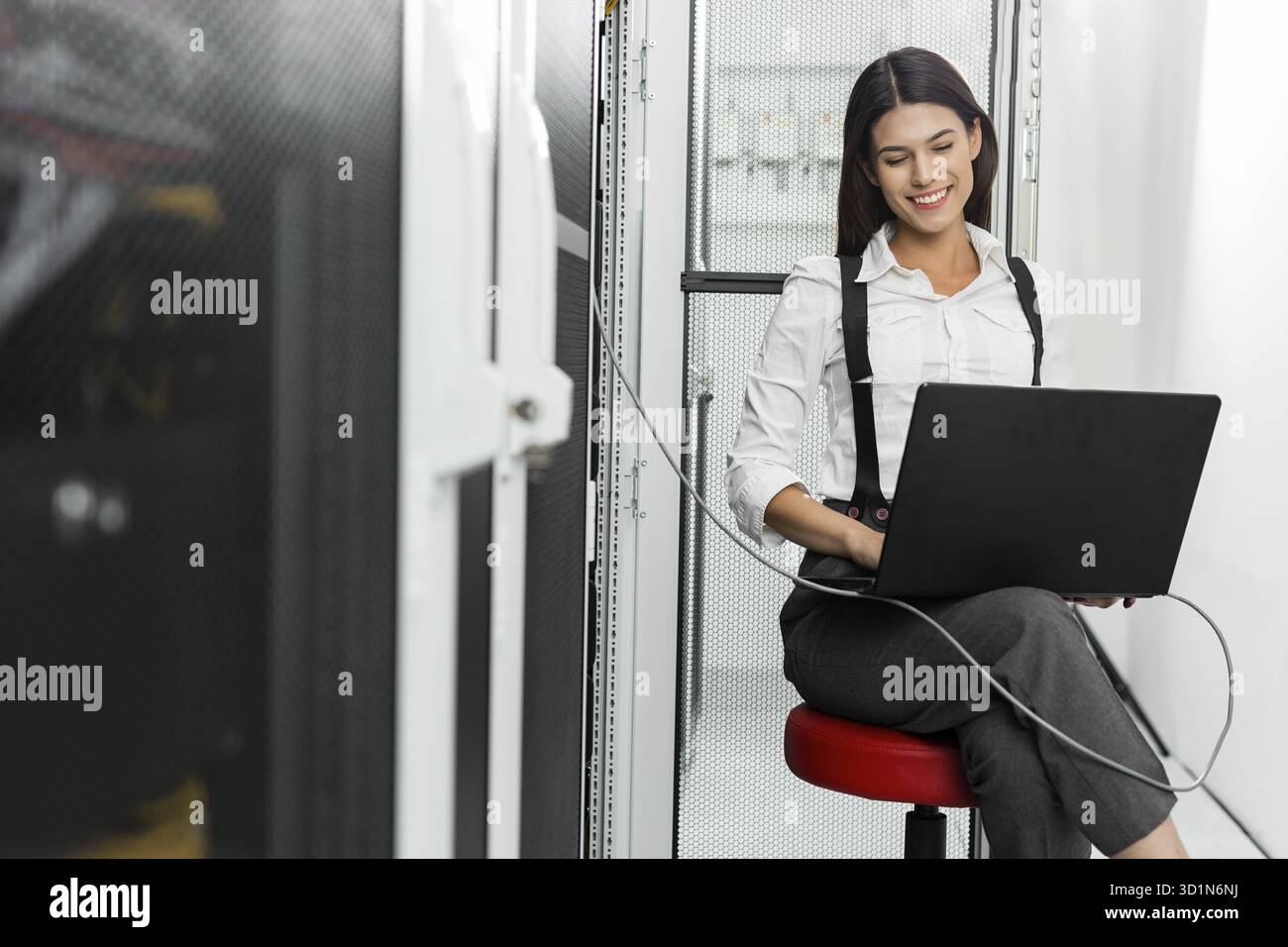 Technician examining server in server room Stock Photo