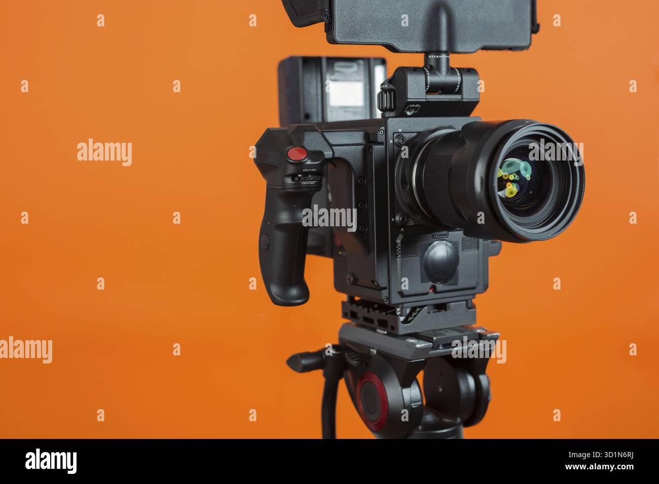 Professional video camera on vivid color background making contrast ...