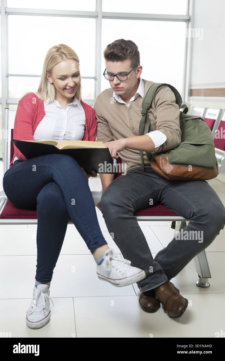Group of young students collaborating on project in library Stock Photo