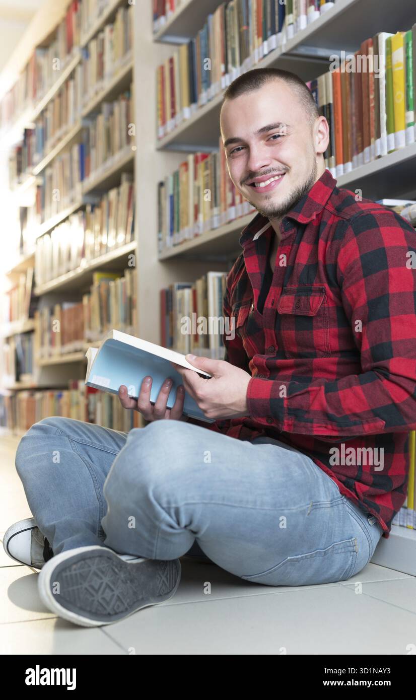 Student preparing exam and learning lessons in school library, making research Stock Photo