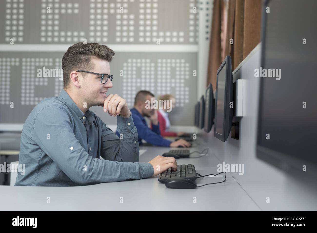 Office with casual dressed workers working on computers Stock Photo
