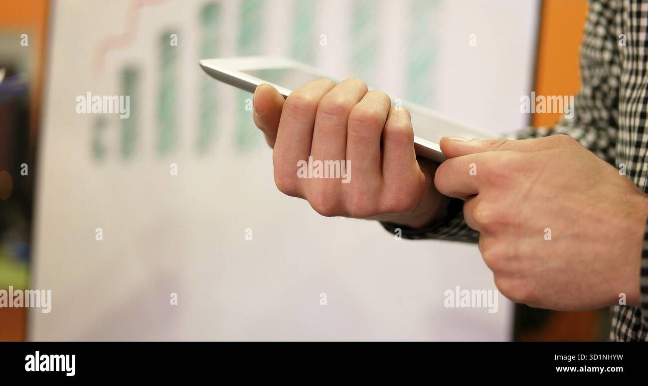 Close up hands multitasking man using tablet, laptop and cellphone connecting wifi Stock Photo