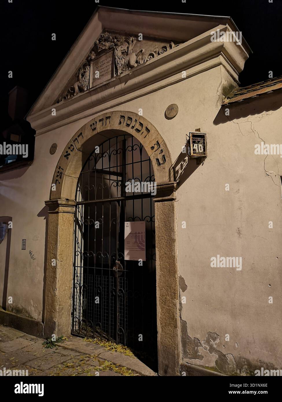 Remuh Synagogue entrance at night, Kazimierz, Krakow – historic Jewish landmark illuminated in Poland’s medieval district rich in heritage and culture - Smartphone Captured Stock Image