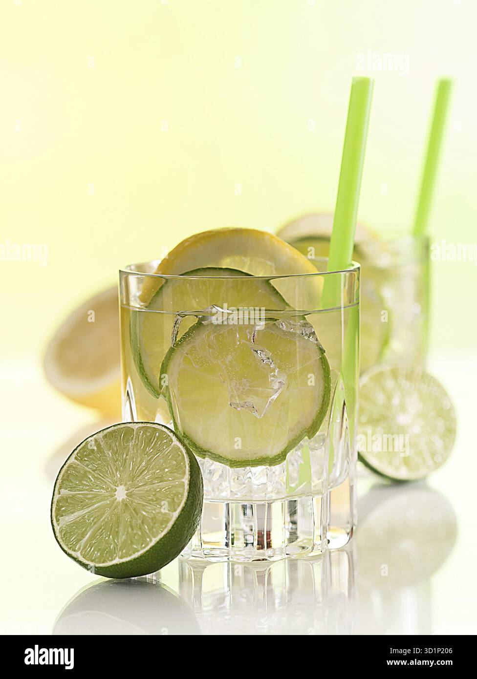 Cocktail with lime, lemon slices and ice cube cubes Stock Photo