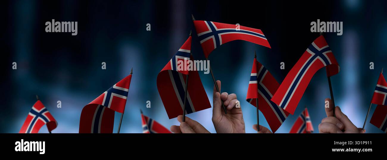 Norway flags in their hands on a blurred urban background. The photo ...