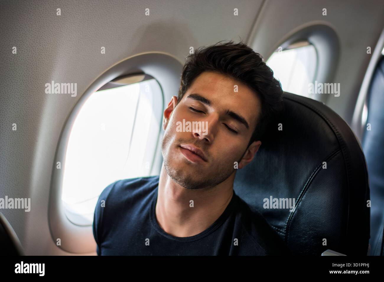 Young man in plane Stock Photo