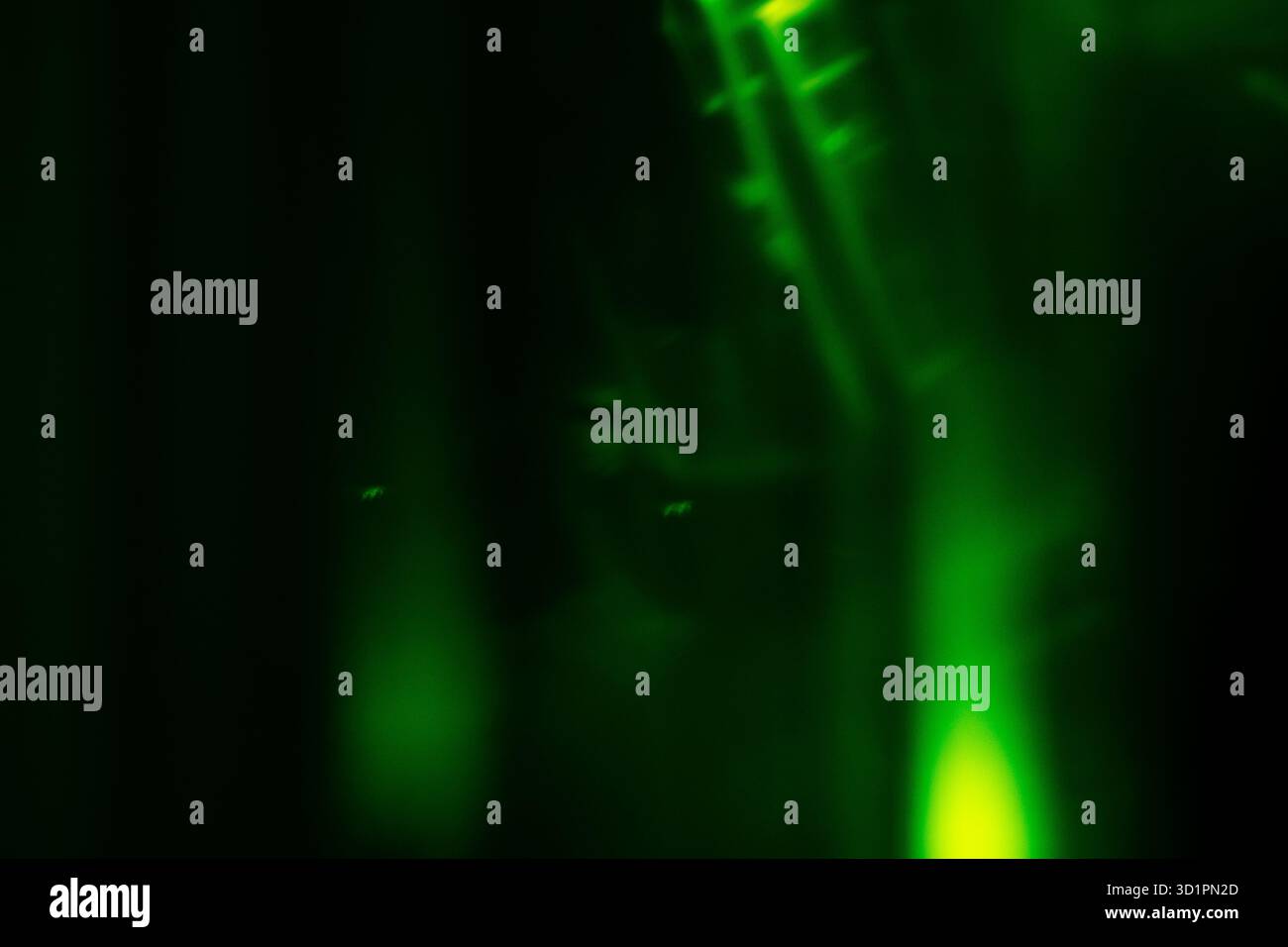 Blurred green magical light effect on black background. Stock Photo