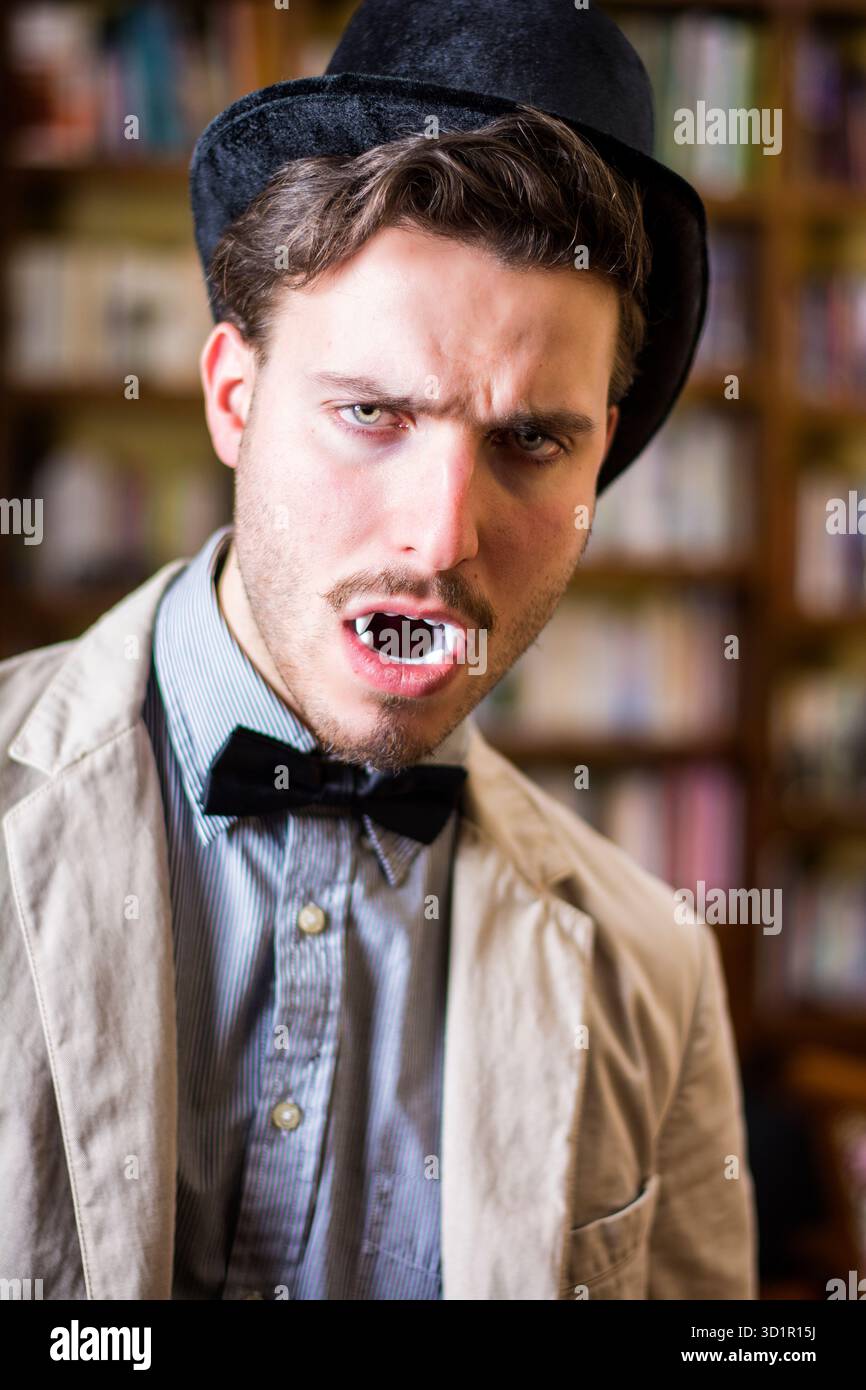 Close up Young Handsome White Vampire with Black Top Hat Stock Photo