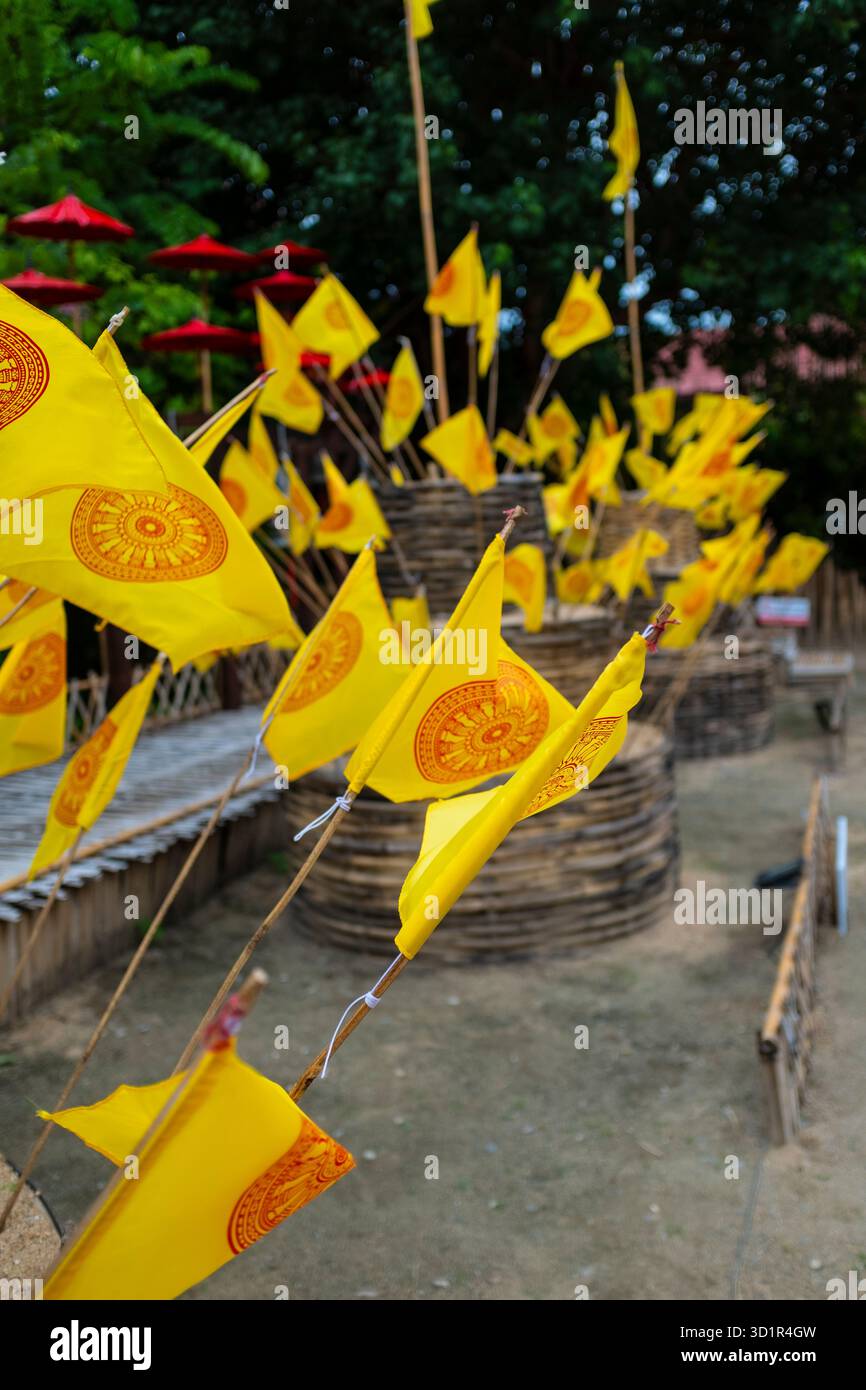 Dharmacakra yellow flags on a buddhist temple in Chiang Rai, Thailand ...