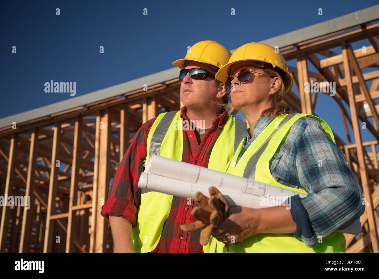 Male and Female Construction Workers at Construction Site Stock Photo