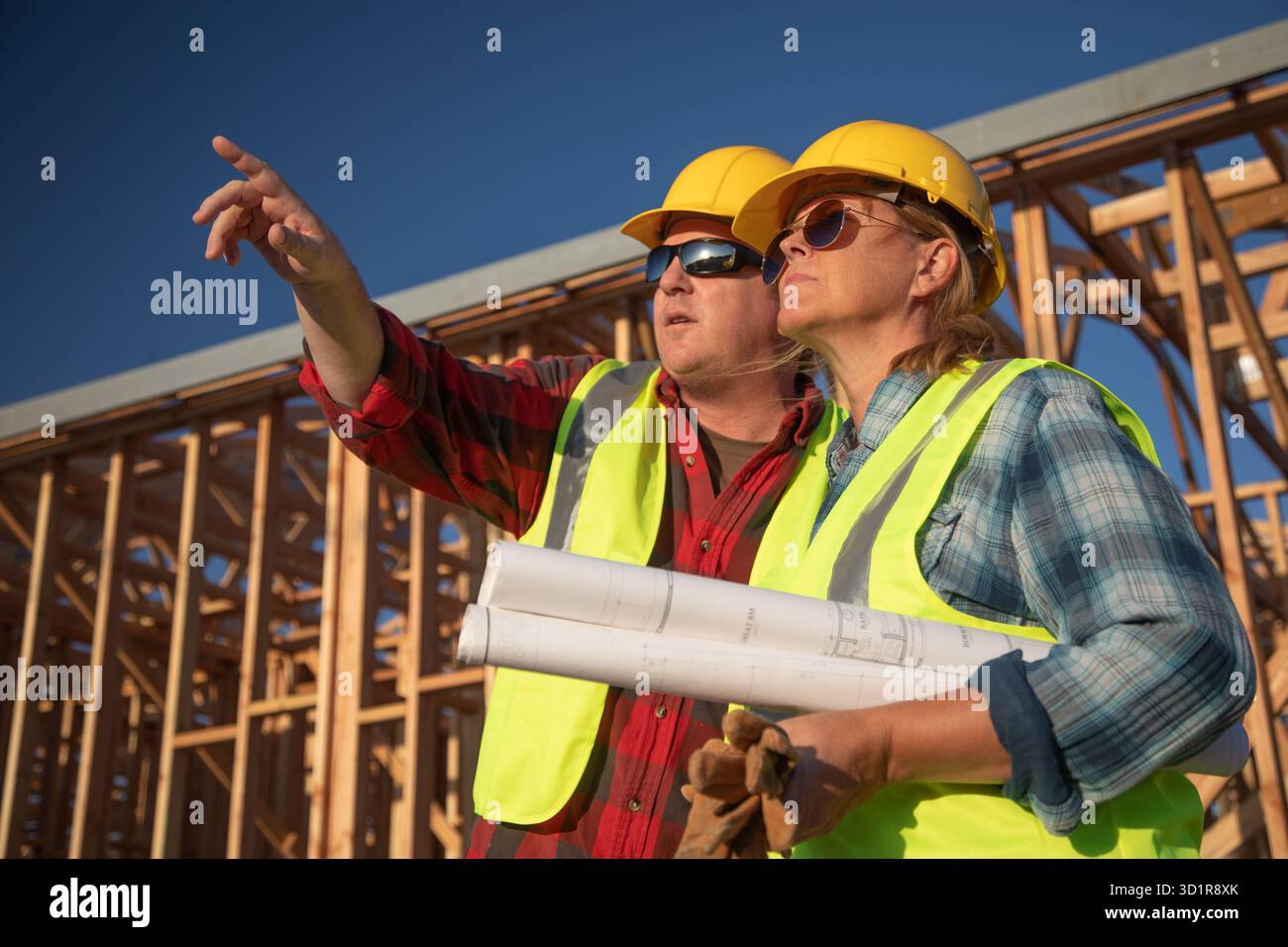 Male and Female Construction Workers at Construction Site Stock Photo