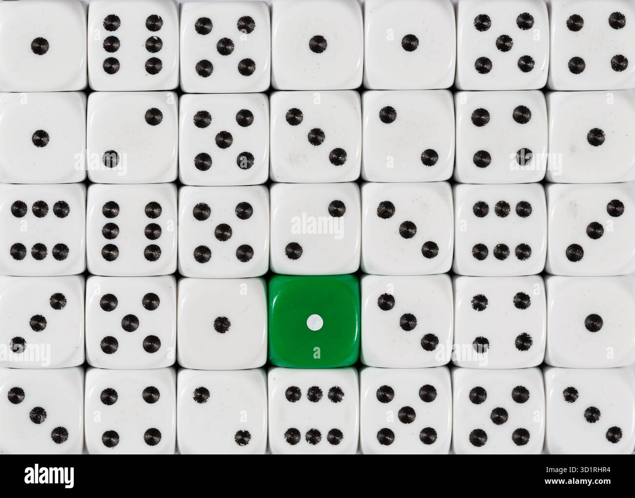 Background of random ordered white dices with one green cube Stock Photo