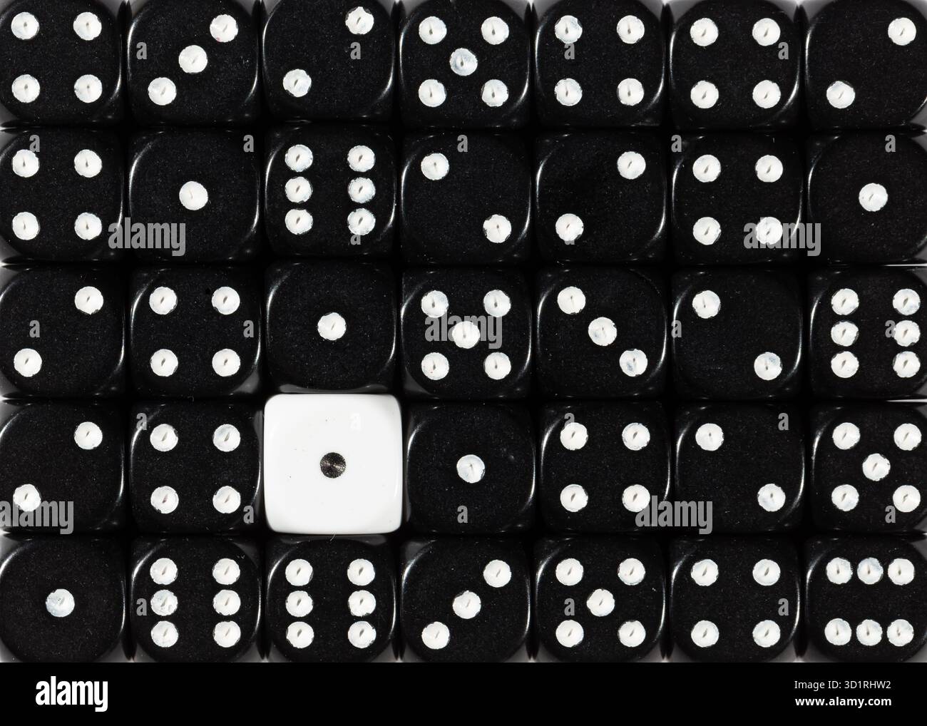 Background of random ordered black dices with one white cube Stock Photo