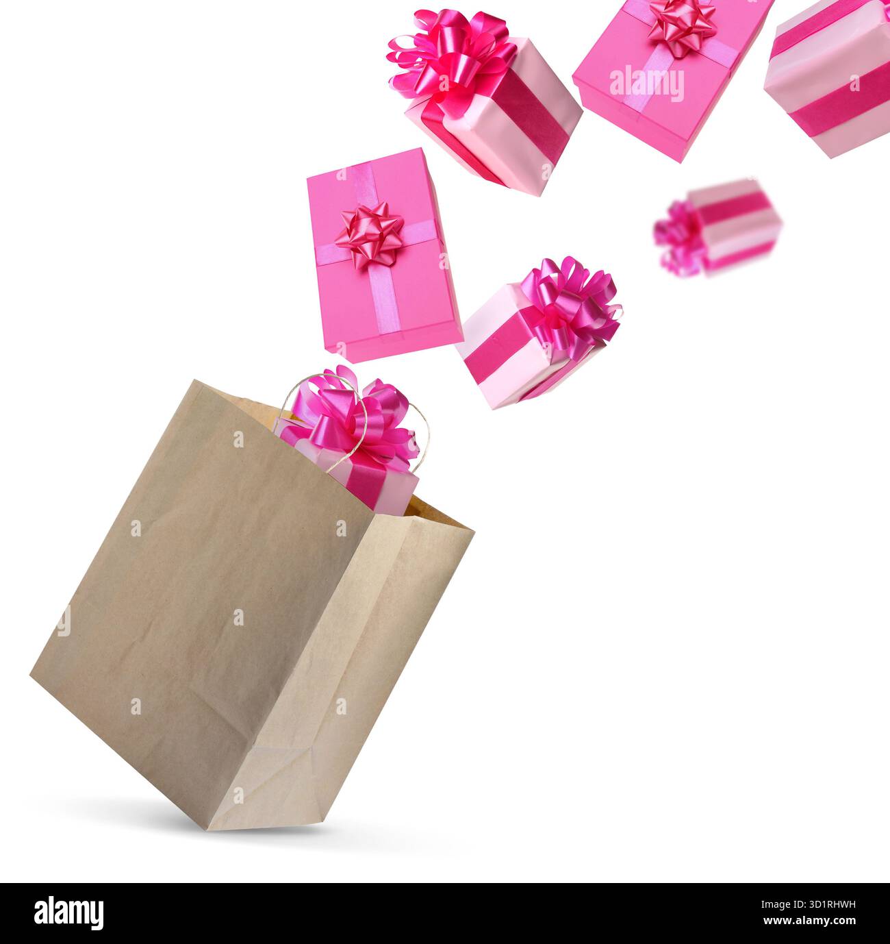 Many gift boxes falling into paper bag on white background Stock Photo
