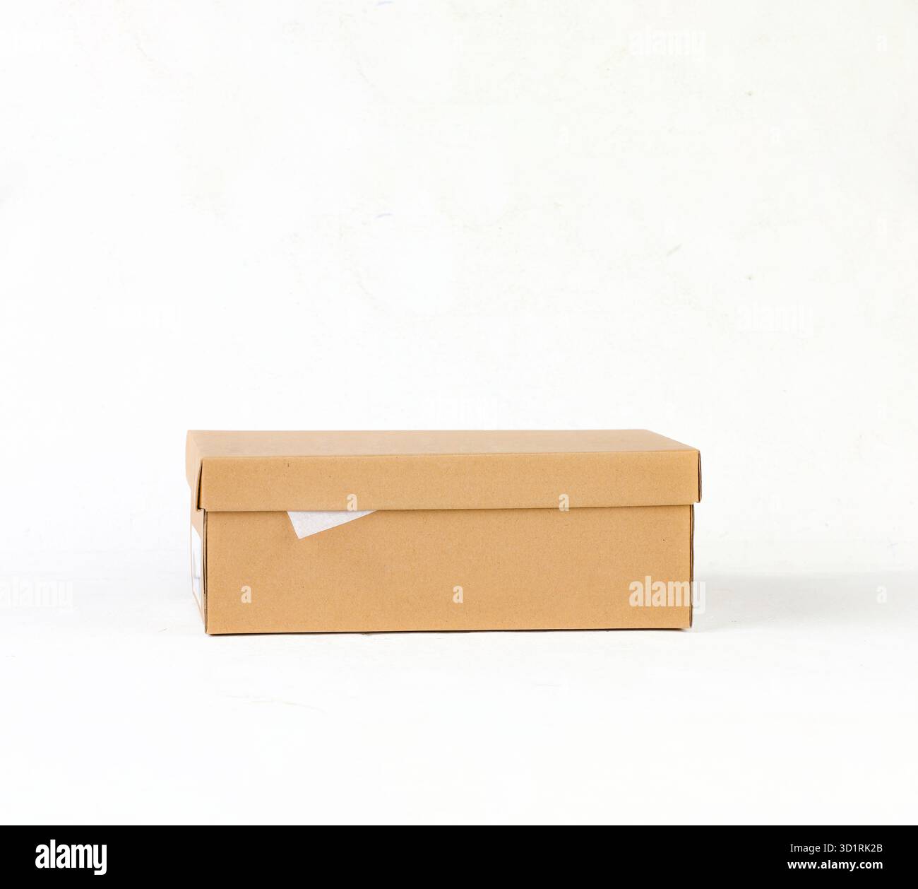 Closed Brown Kraft Cardboard Box on White Background Stock Photo
