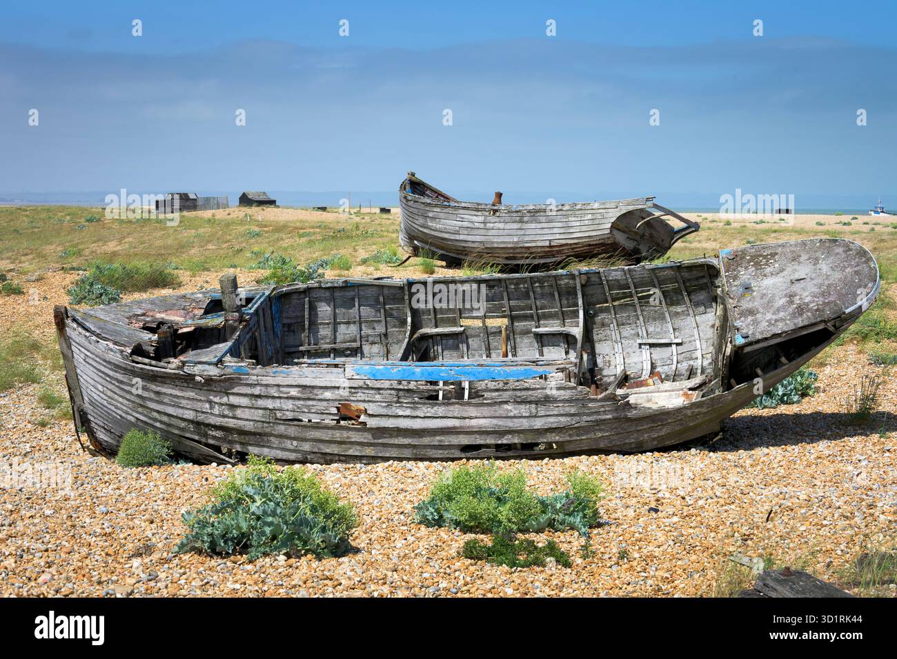Abandoned fishing boats on a shingle beach in Dungeness, Kent, England ...