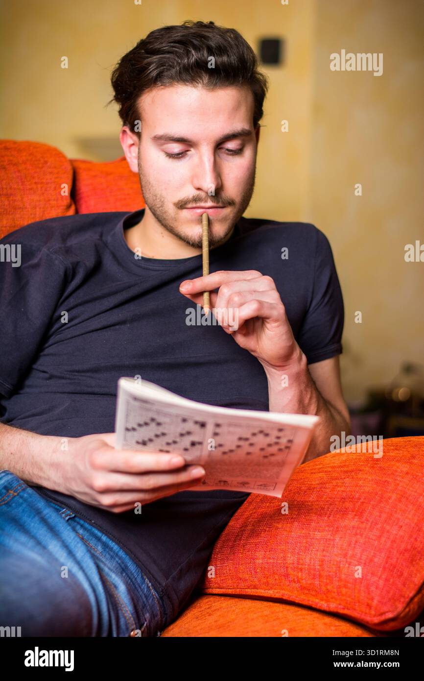 Man doing crossword puzzle hi-res stock photography and images