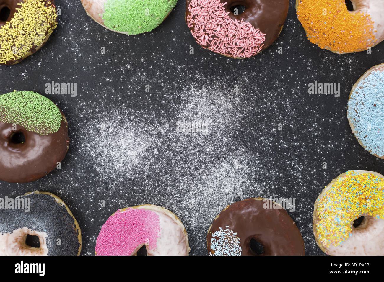 Colorful donuts on stone table. Top view with copy space Stock Photo