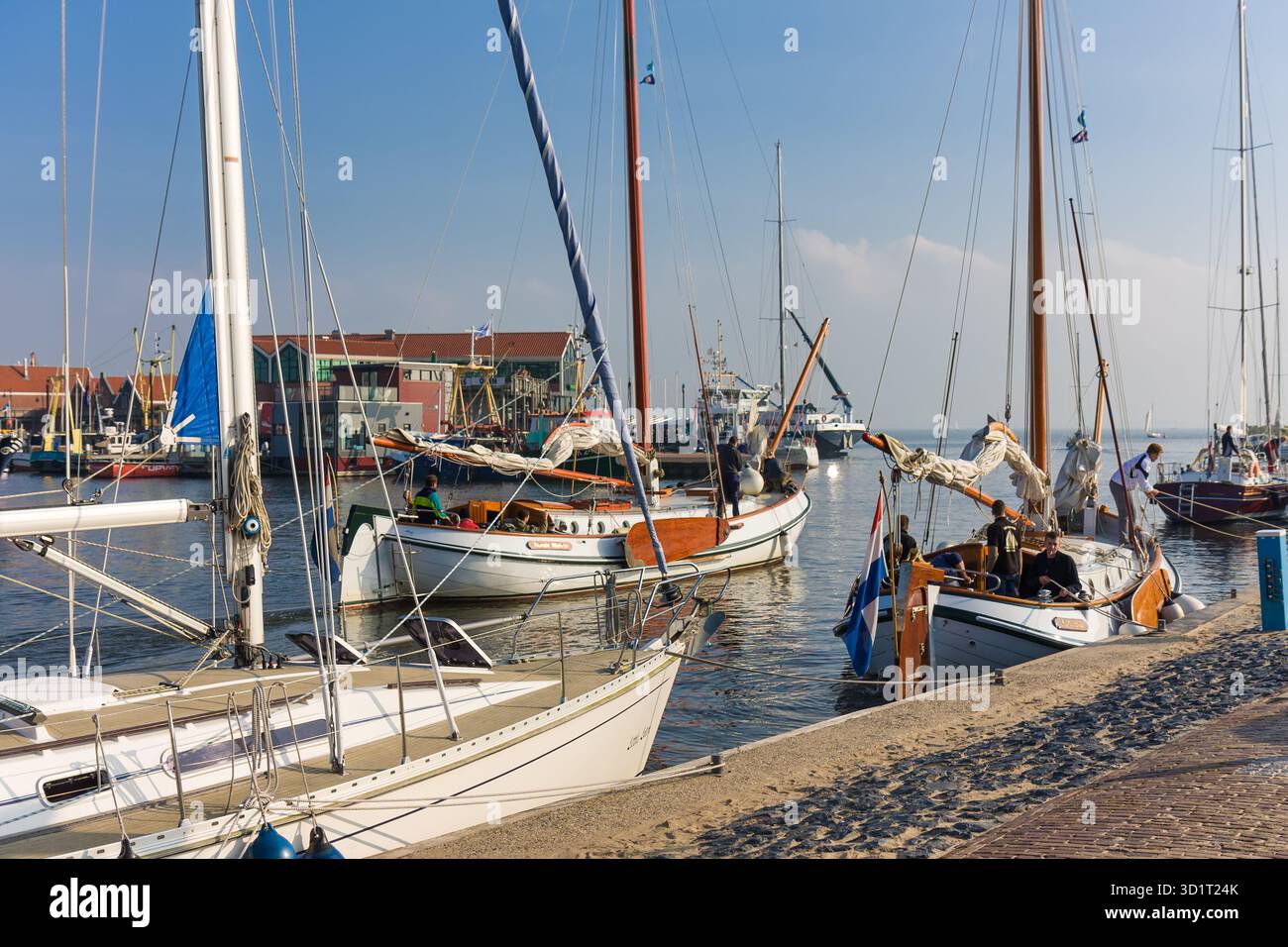 Historic sailing ships leaving harbor of Urk, The Netherlands Stock Photo