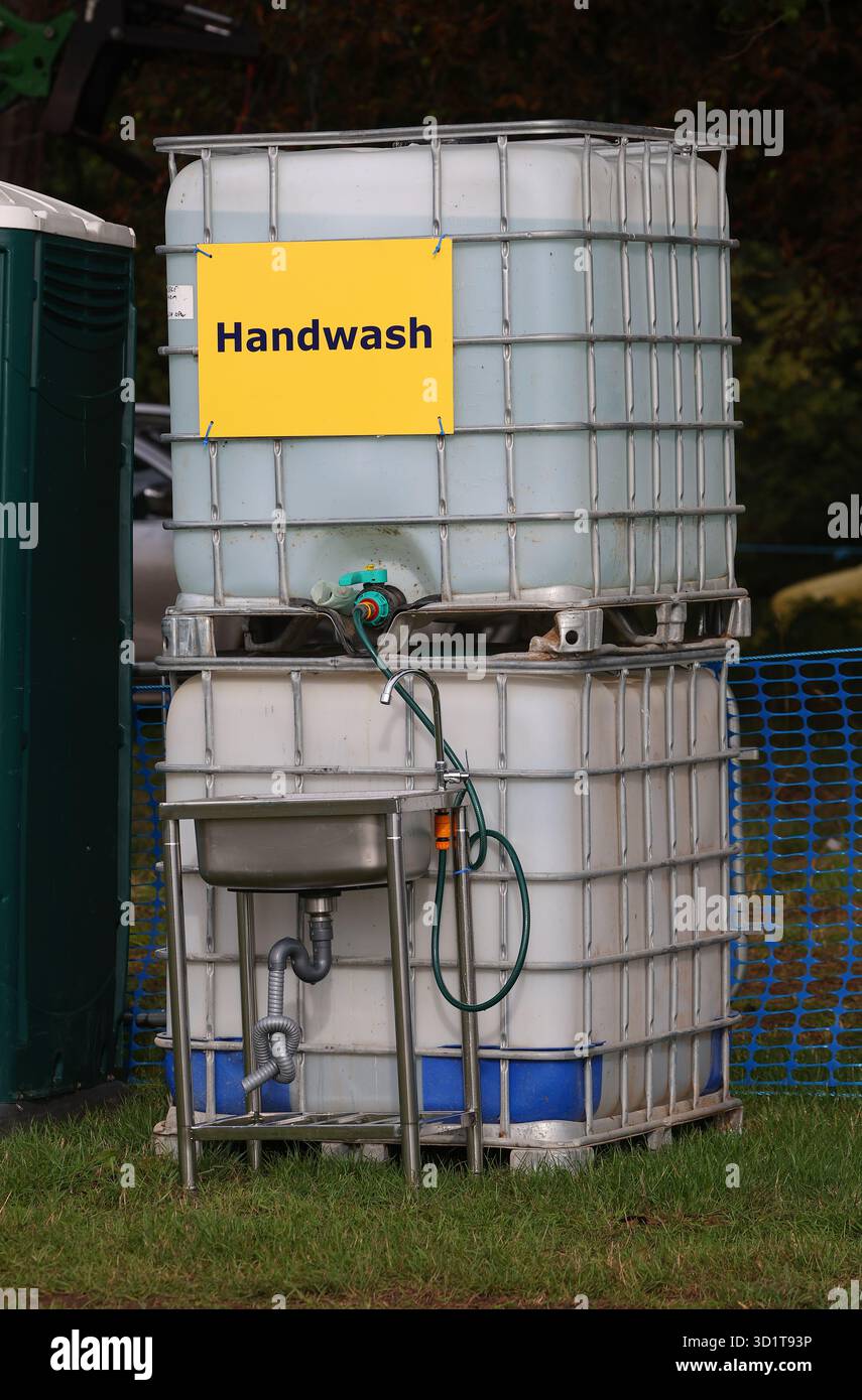 recycled IBC container converted to a hand wash station at a country fare Stock Photo
