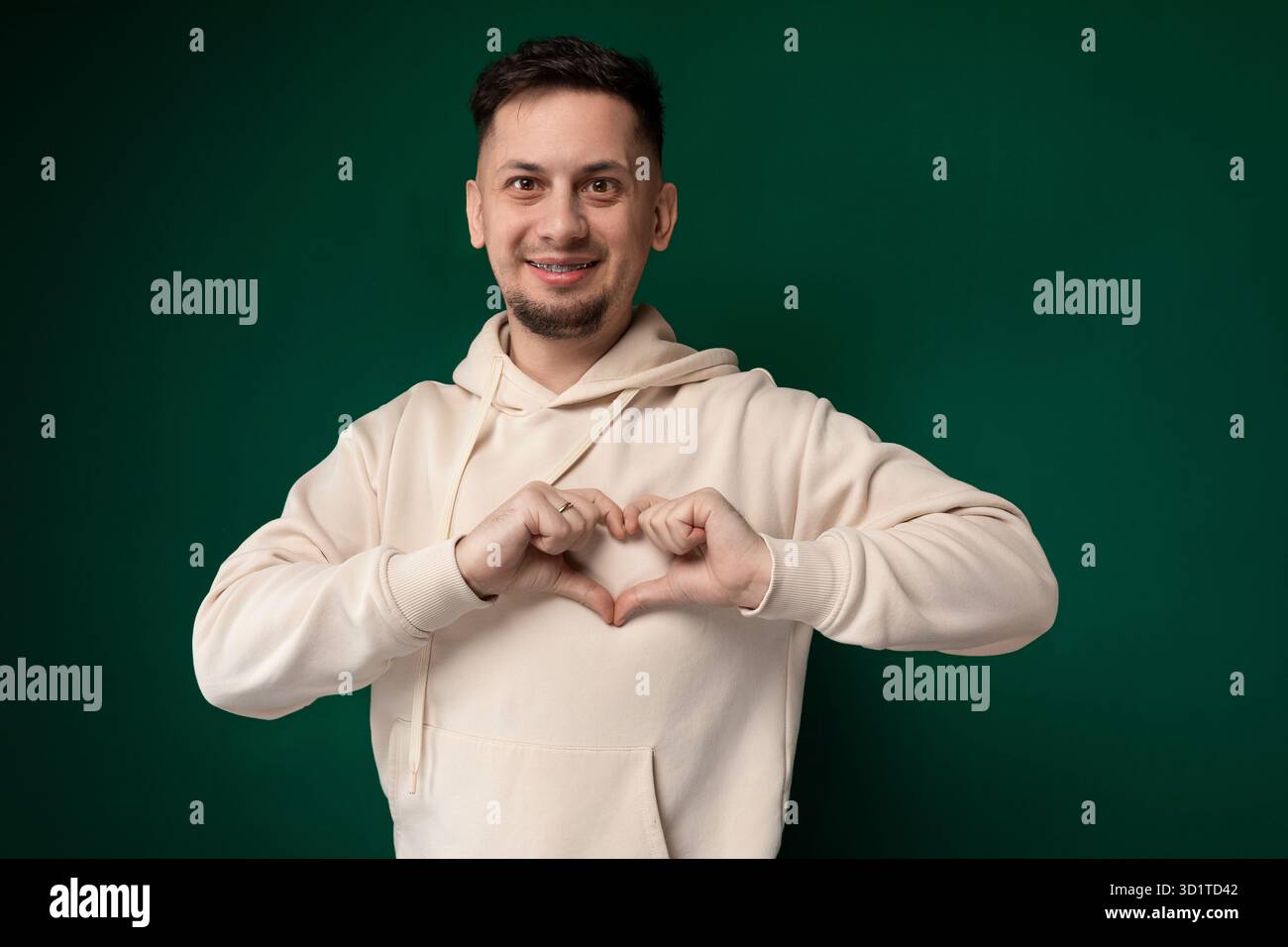 Man Making Heart Gesture With His Hands Stock Photo