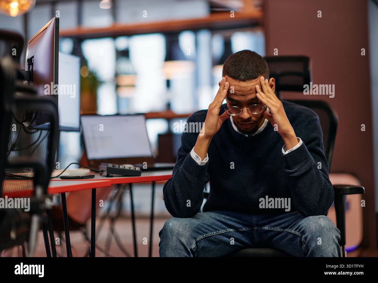 Exhausted African American Programmer Resting at Work. Stock Photo