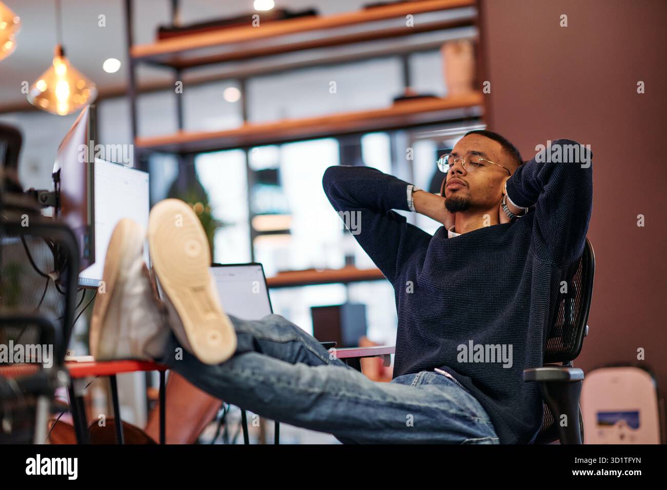 Exhausted African American Programmer Resting at Work. Stock Photo