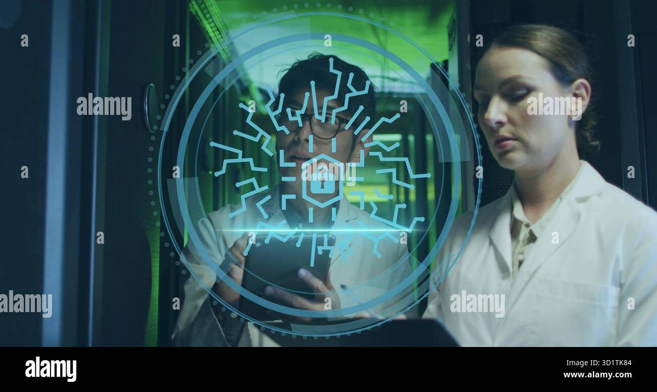 Two technicians in lab coats analyzing tablet in data center aisle, with holographic interface Stock Photo