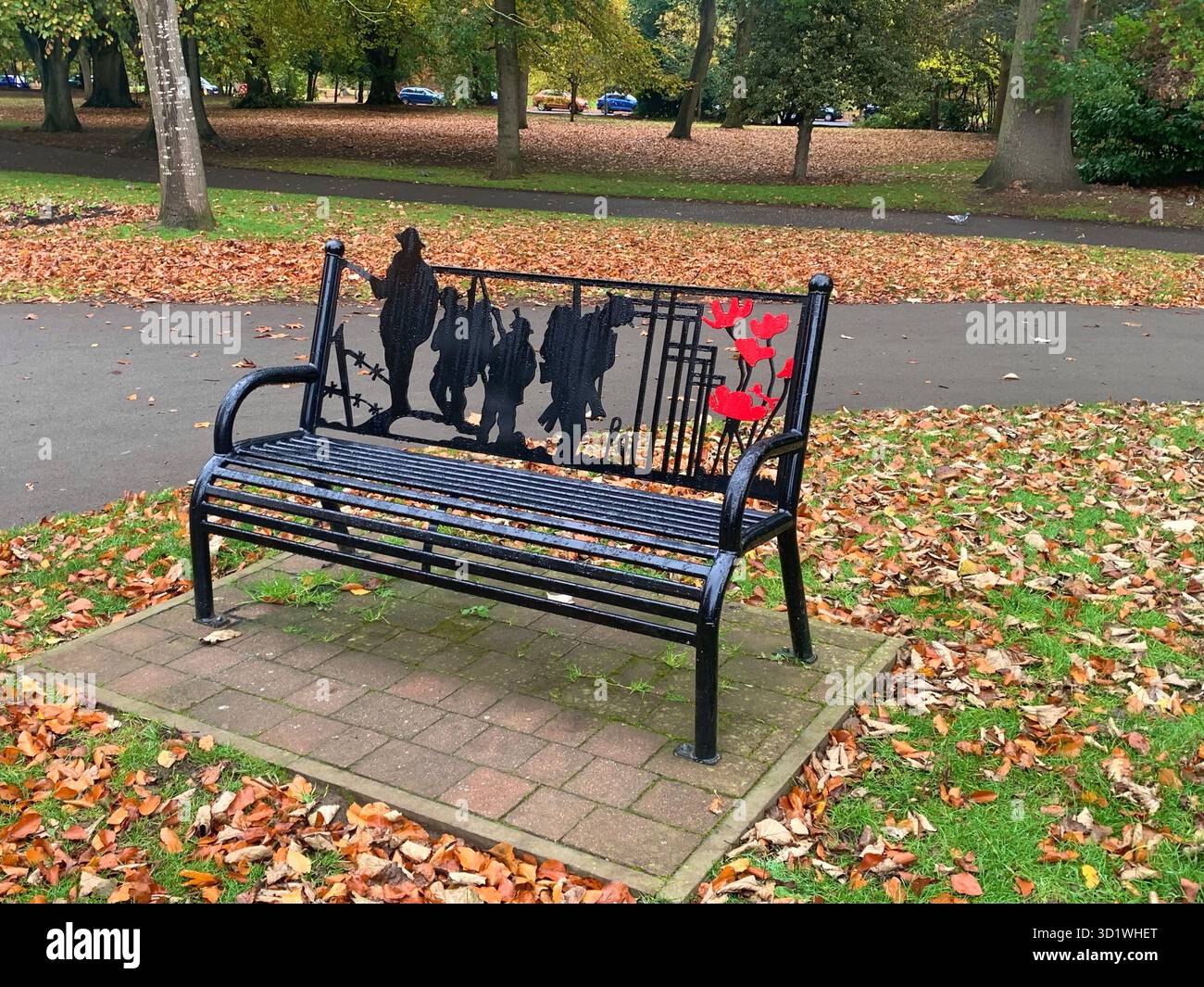 Poppy Day November 11 War Soldiers Soldier Rememberance Sunday seat chair black metal statue popeys form person kneeling  outside bench person - Smartphone Captured Stock Image