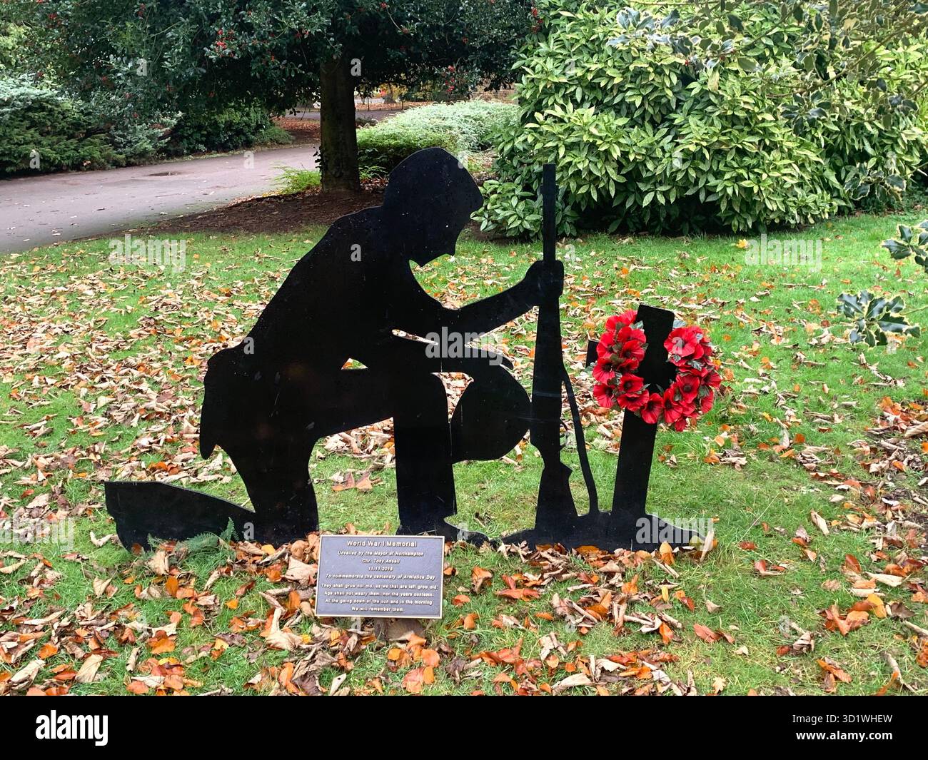 Poppy Day November 11 War Soldiers Soldier Rememberance Sunday seat chair black metal statue popeys form person kneeling  outside bench person - Smartphone Captured Stock Image