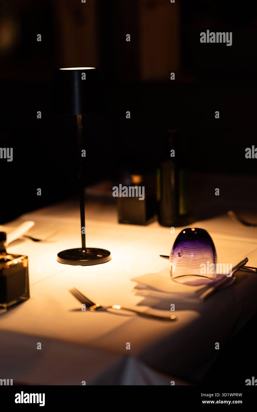 Blue Glass Upside Down on White Tablecloth Stock Photo