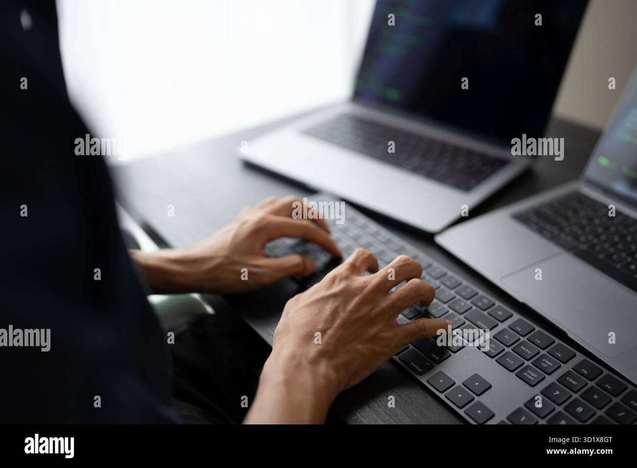 Asian man software engineer Working on Computer at office desk for writing program code IT Software Engineer finding errors tech Stock Photo