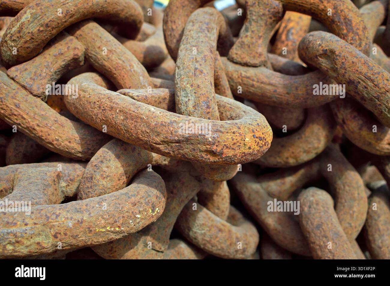 Heavy rusty industrial chains in storage yard. Stock Photo