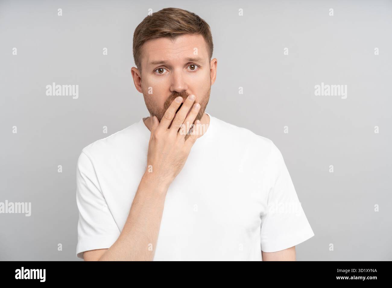 Sleepy middle-aged man yawning of tiredness, overworking, chronic fatigue, restless night, insomnia Stock Photo