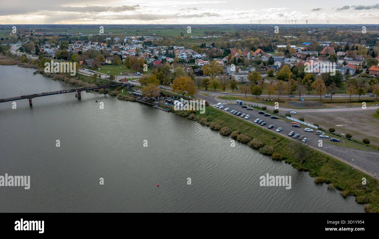 Low Rise Embankment Aerial view shows a riverside town near Malbork, Poland, with a long ...