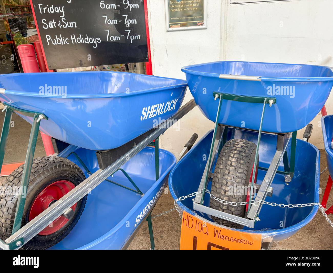 Bunnings warehouse store, Sherlock made wheelbarrows able to carry 100 litres capacity, for sale outside entrance to the store, Sydney,Australia - Smartphone Captured Stock Image