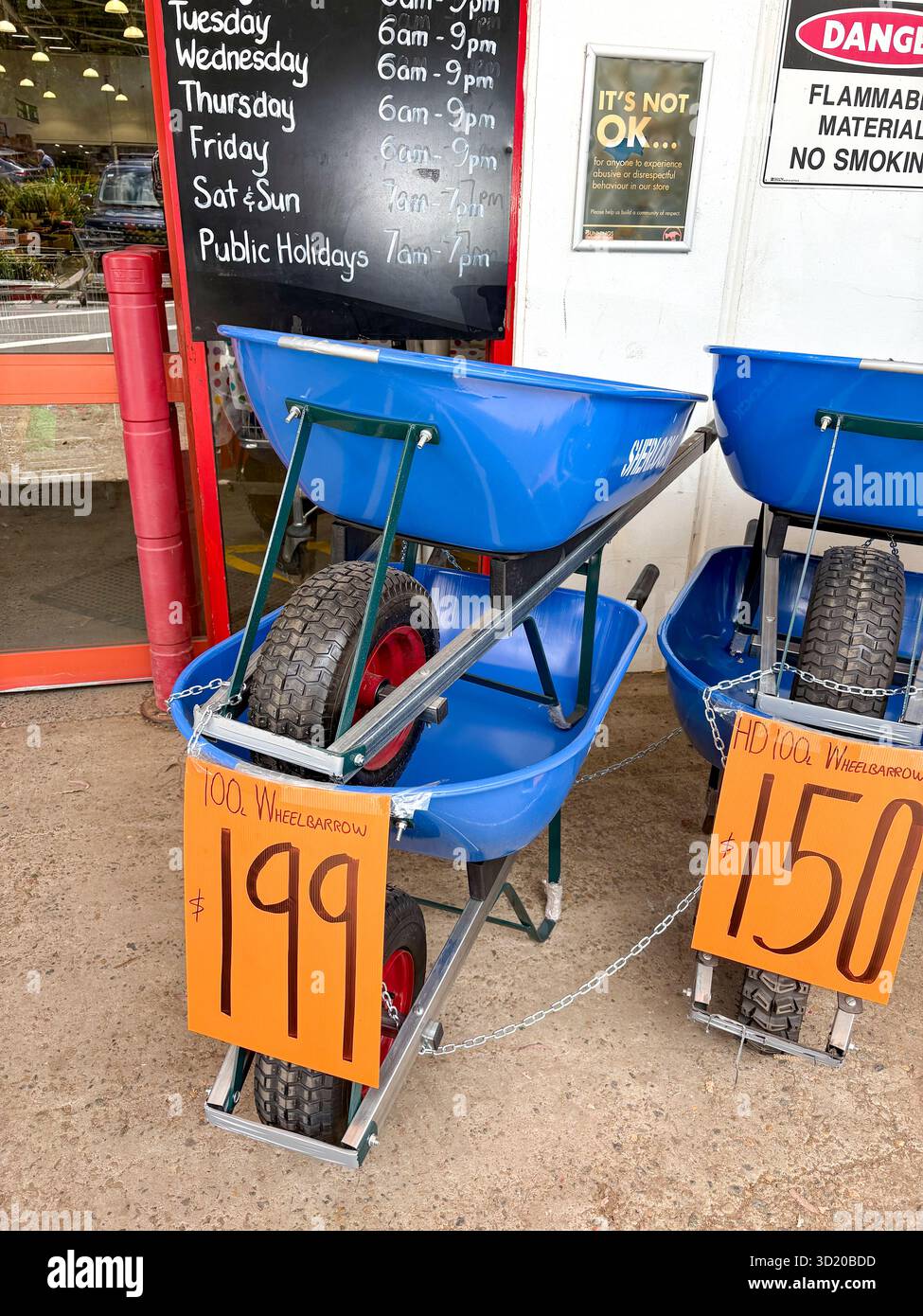 Bunnings warehouse store, Sherlock made wheelbarrows able to carry 100 litres capacity, for sale outside entrance to the store, Sydney,Australia - Smartphone Captured Stock Image