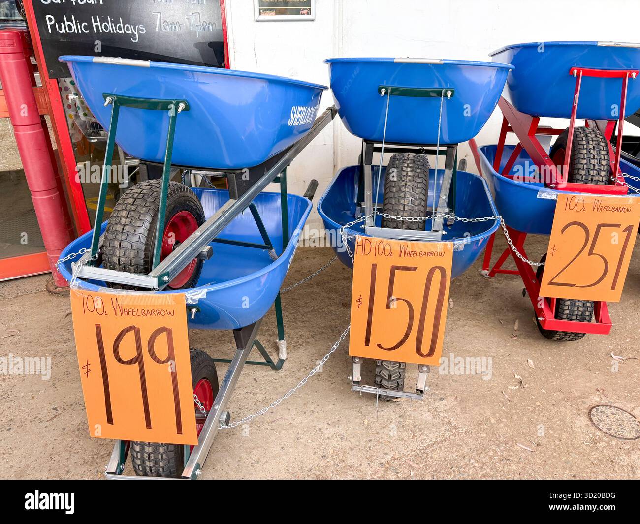 Bunnings warehouse store, Sherlock made wheelbarrows able to carry 100 litres capacity, for sale outside entrance to the store, Sydney,Australia - Smartphone Captured Stock Image