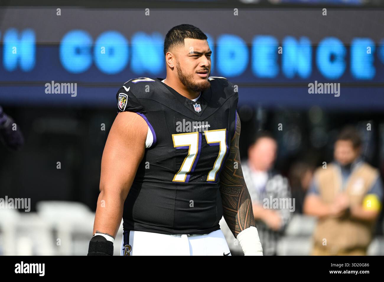 Baltimore Ravens guard Daniel Faalele (77) looks on during pre-game ...