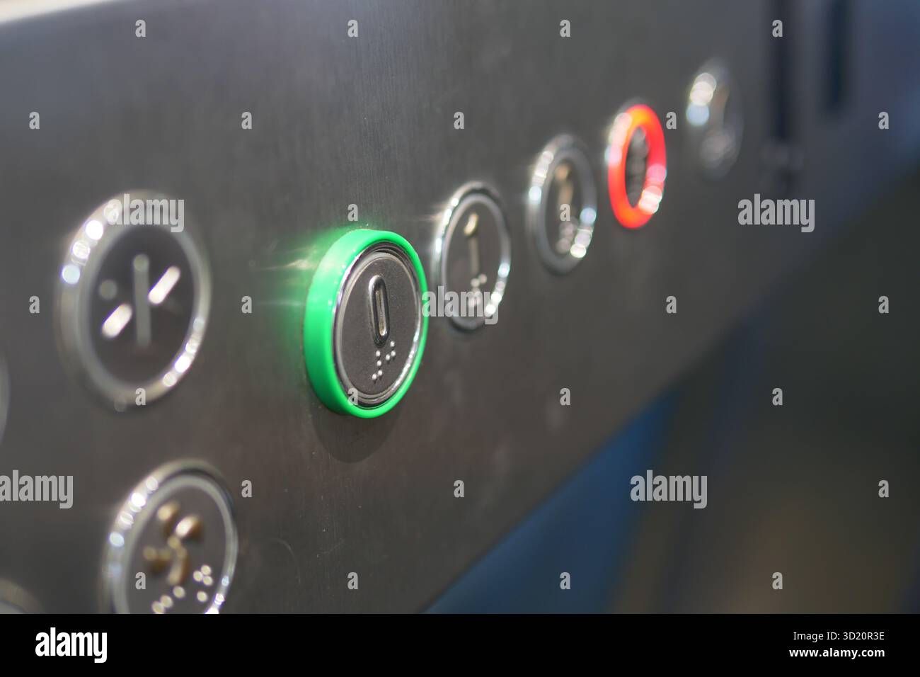 Illuminated elevator control panel in a building Stock Photo