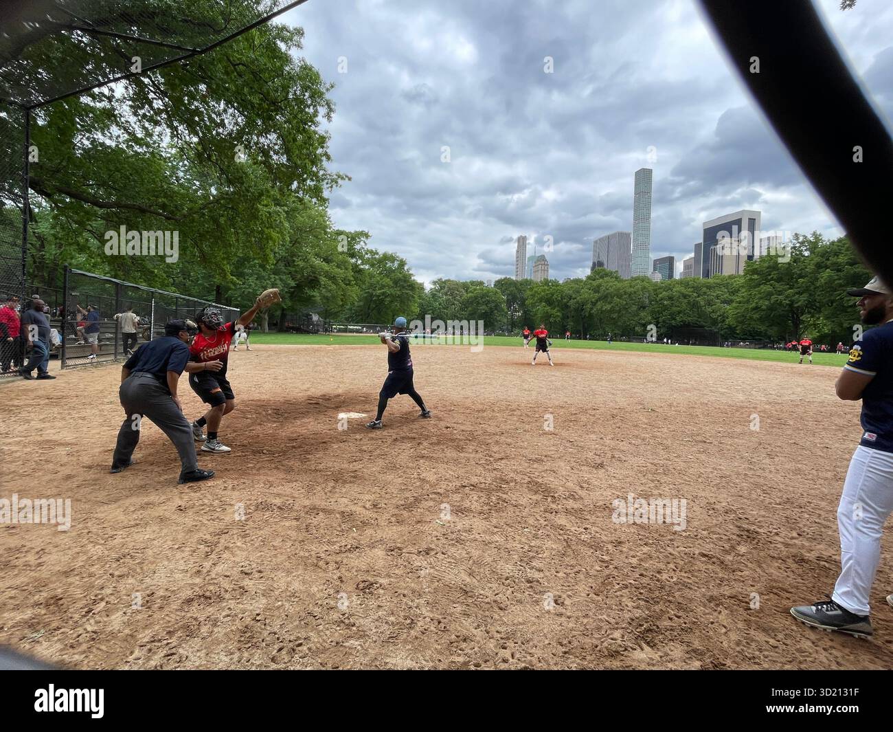 Central Park comes alive with the energy of baseball enthusiasts in action - Smartphone Captured Stock Image