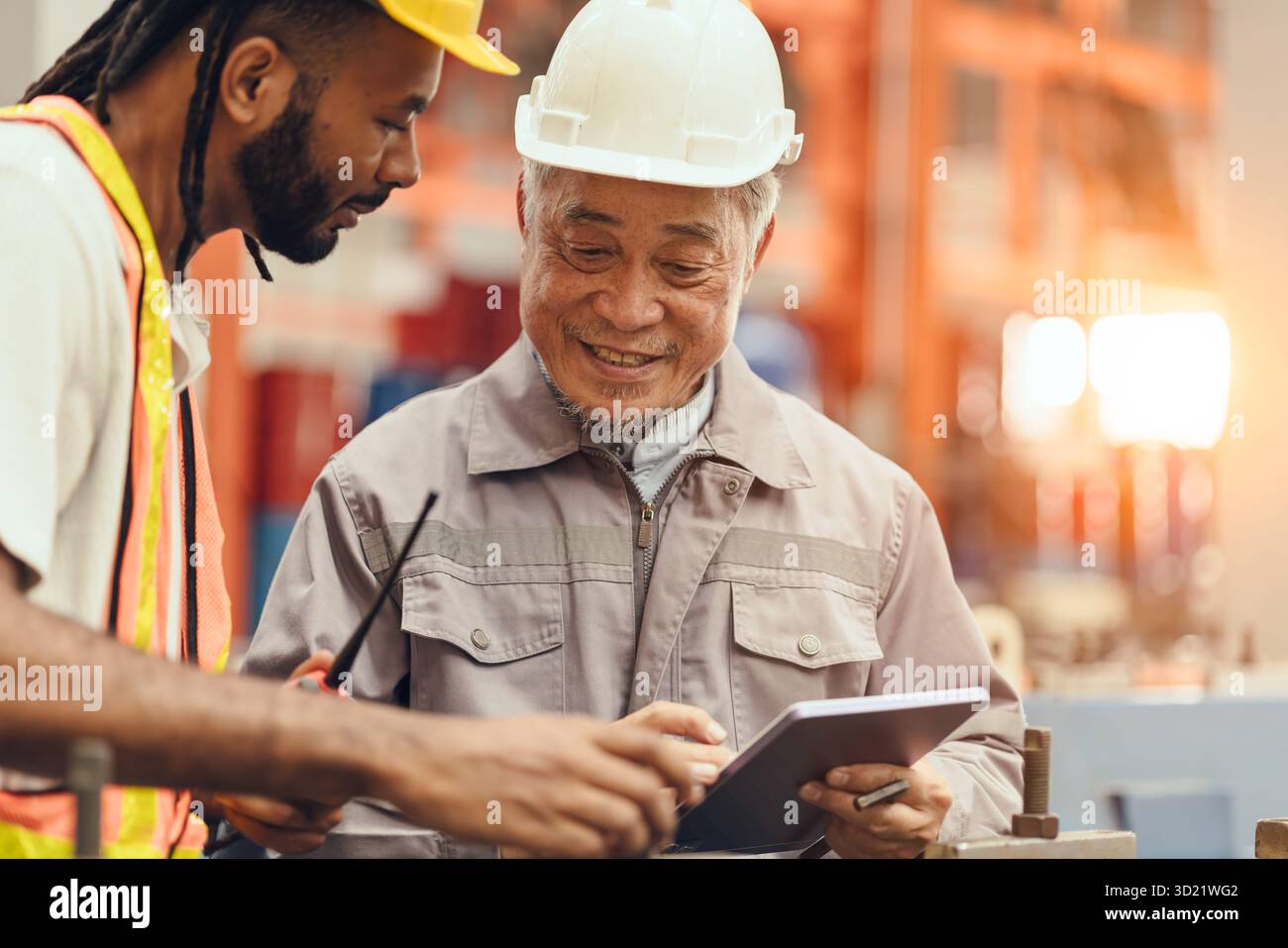 Professional healthy smiling senior engineer worker, Japanese expert engineer male happy working with young technician Stock Photo
