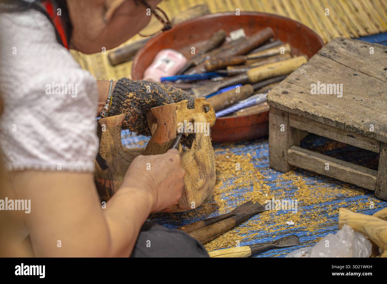 Woodcarving craftsmanship worker closeup working, delicate, detailed, meticulous, beautiful wooden work Stock Photo