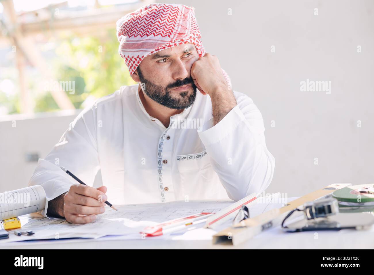 Arab construction engineer architect, Muslim builder working at desk at construction site design floor plan thinking idea Stock Photo
