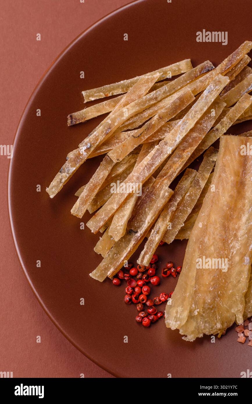 Dried salted fish, snacks or jerky, slices of white fish fillets. Jerks ...