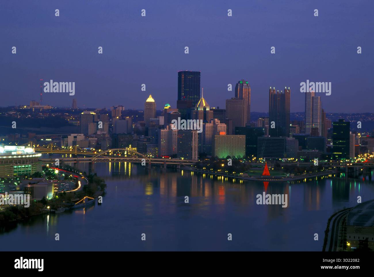 Steel City Shines: Pittsburgh's 2003 Skyline Reflects in the Glow of Three Rivers Stock Photo