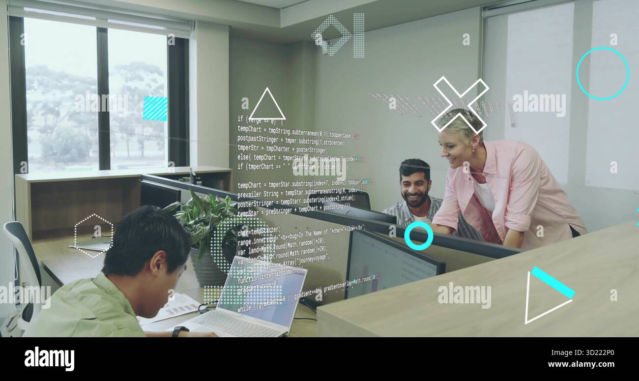 Collaborating software developers reviewing code in open-plan office, with monitors and laptop Stock Photo