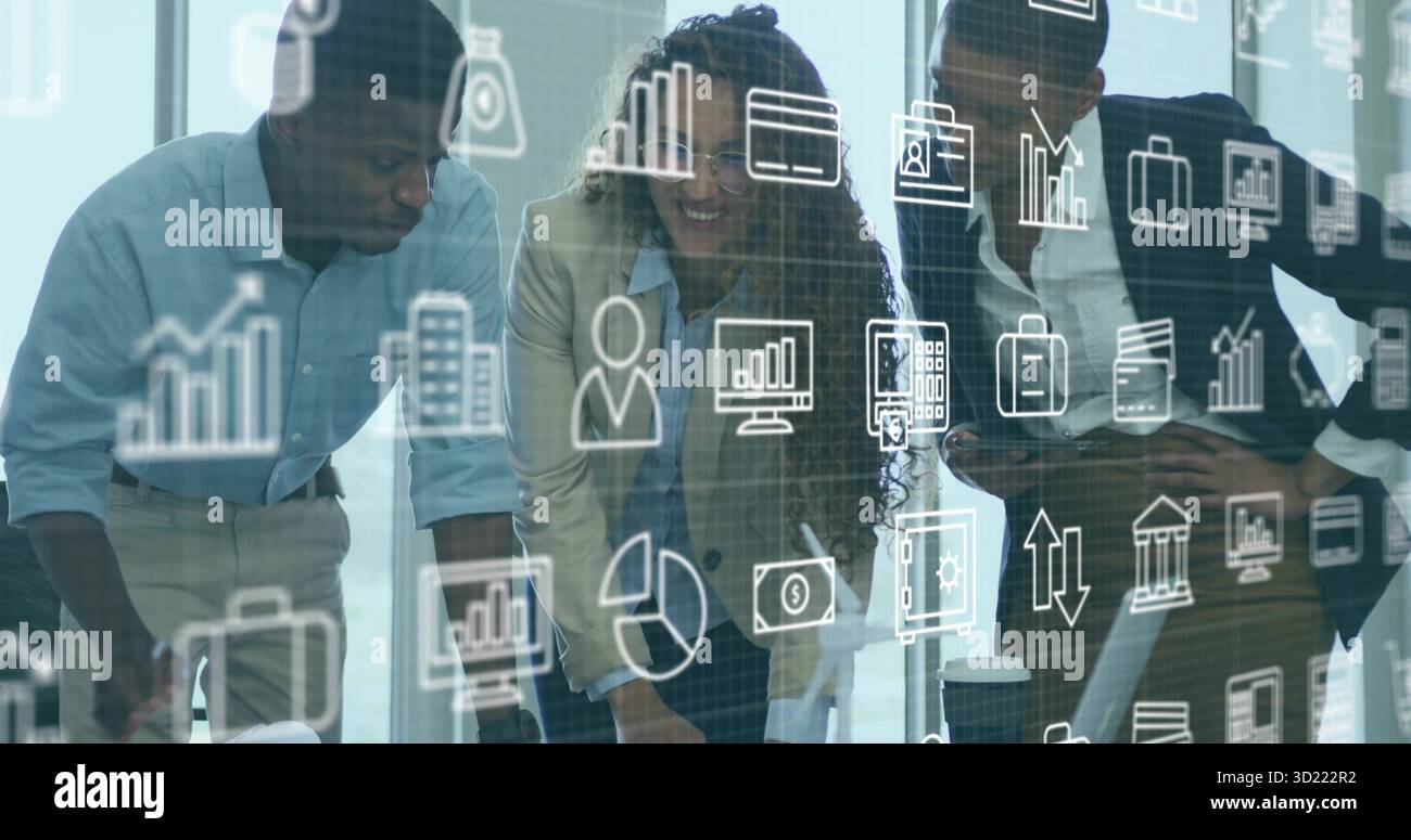 Leaning three-person team reviewing laptop and documents in glass-walled room, with analytics icons Stock Photo