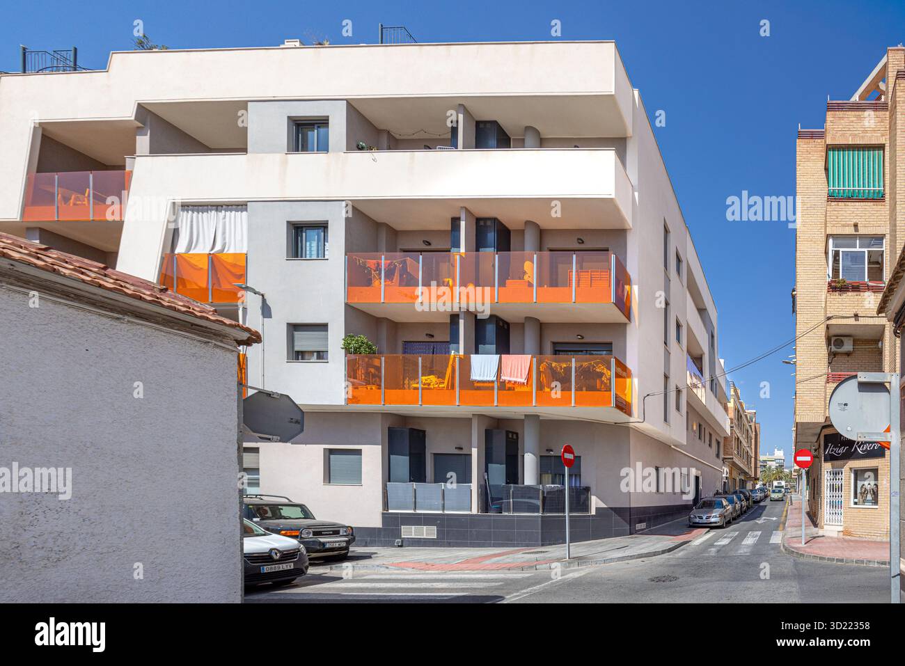 Picture Idea: Contemporary Apartment Complex Featuring Bold Orange Balconies In Urban