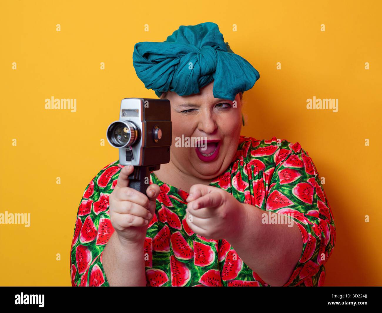 Retro plus size woman filming with vintage camera Stock Photo - Alamy